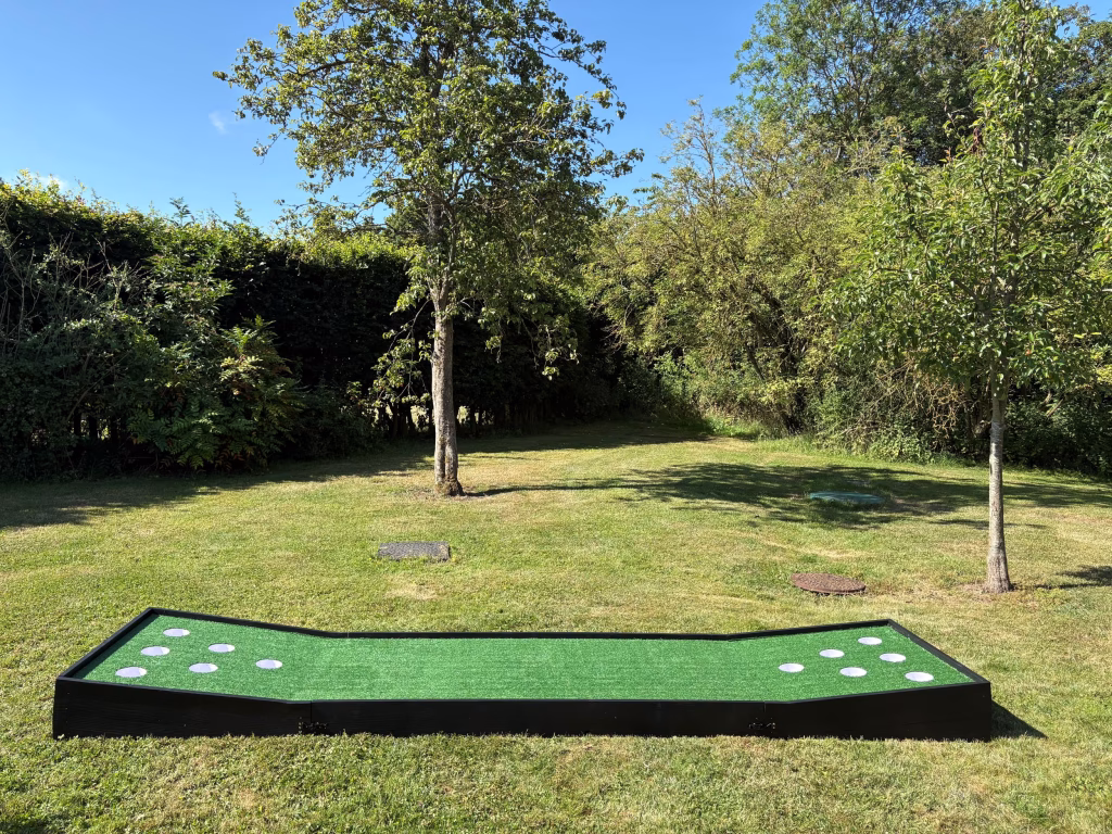 Battle Putt giant putting game set up outdoors with six holes for wedding garden games and corporate event entertainment hire.