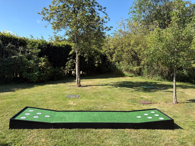 Battle Putt giant putting game set up outdoors with six holes for wedding garden games and corporate event entertainment hire.