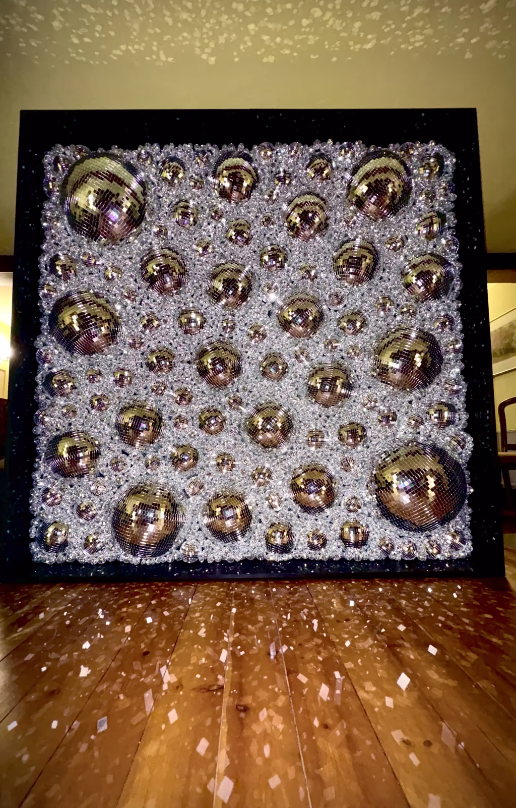 Disco Ball Wall Backdrop lit up at night sparkling event decor for weddings and parties