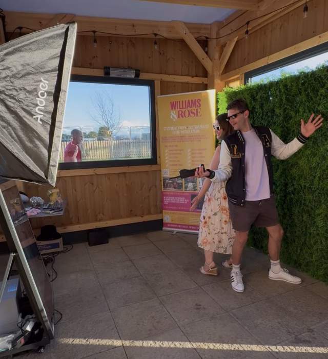 Guests Having their photo taken in the Magic Mirror Photo Booth with a Fern Wall backdrop at the Norfolk Food Hall Norfolk Edit's Creator Networking Event