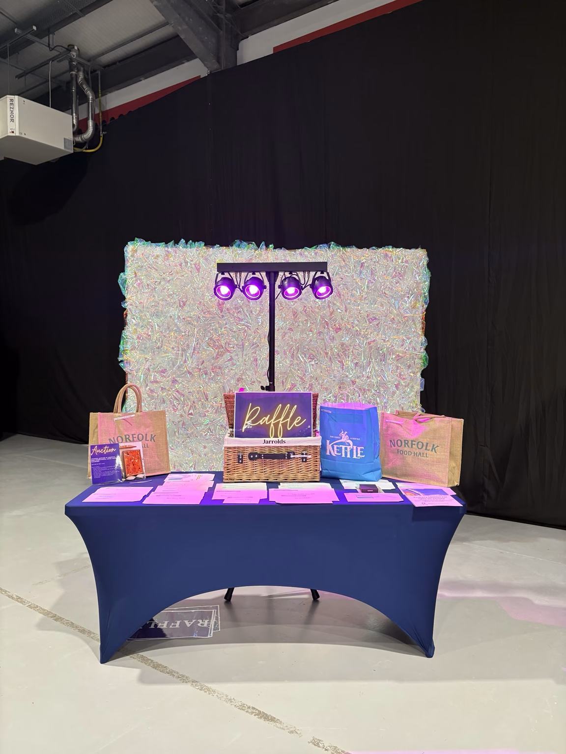 Williams & Rose Holographic Wall used as the backdrop to the raffle and auction prize table at the RNAA Glitter Ball.