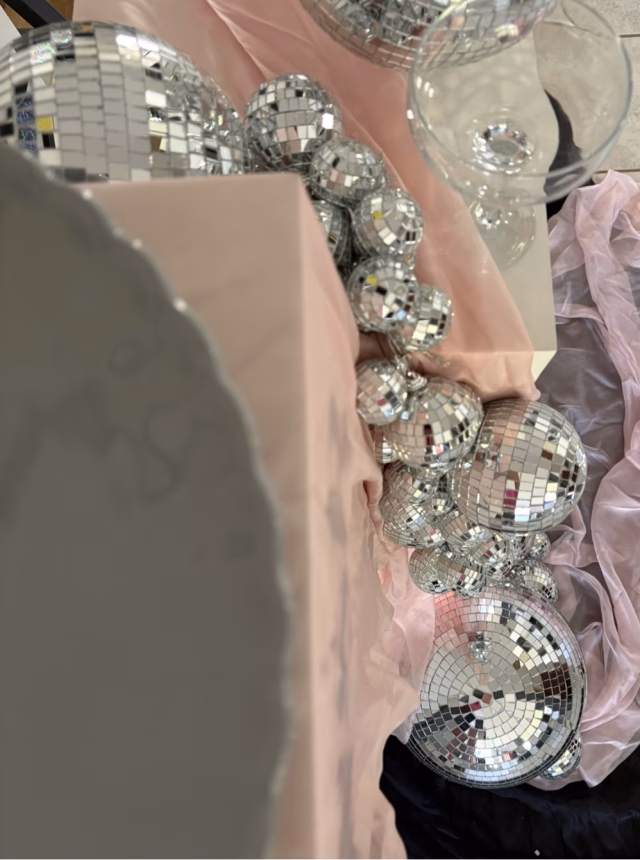 Overhead view of mirrorballs arranged with soft draping.