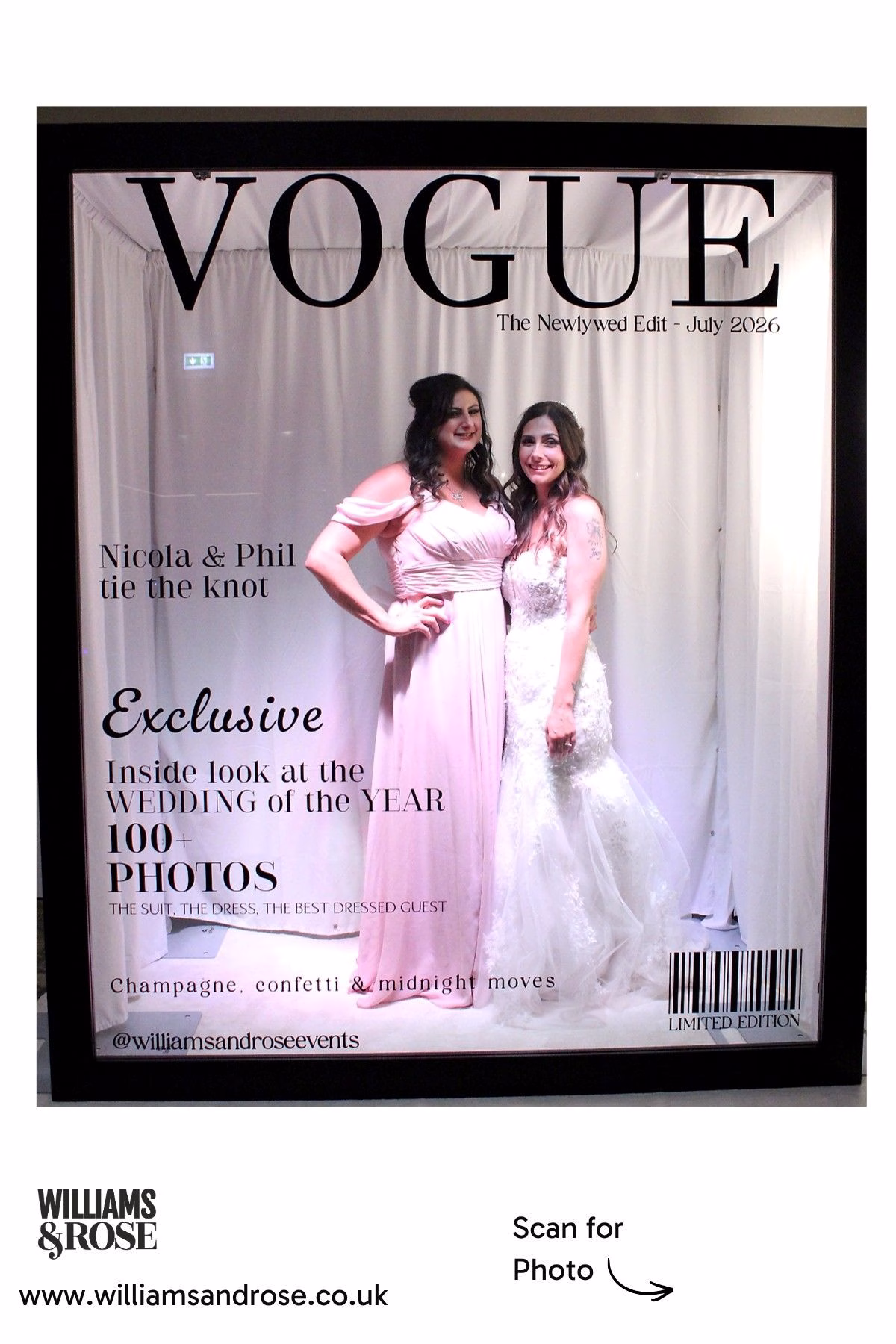 Two female wedding guests posing together inside the Magazine Photo Booth.