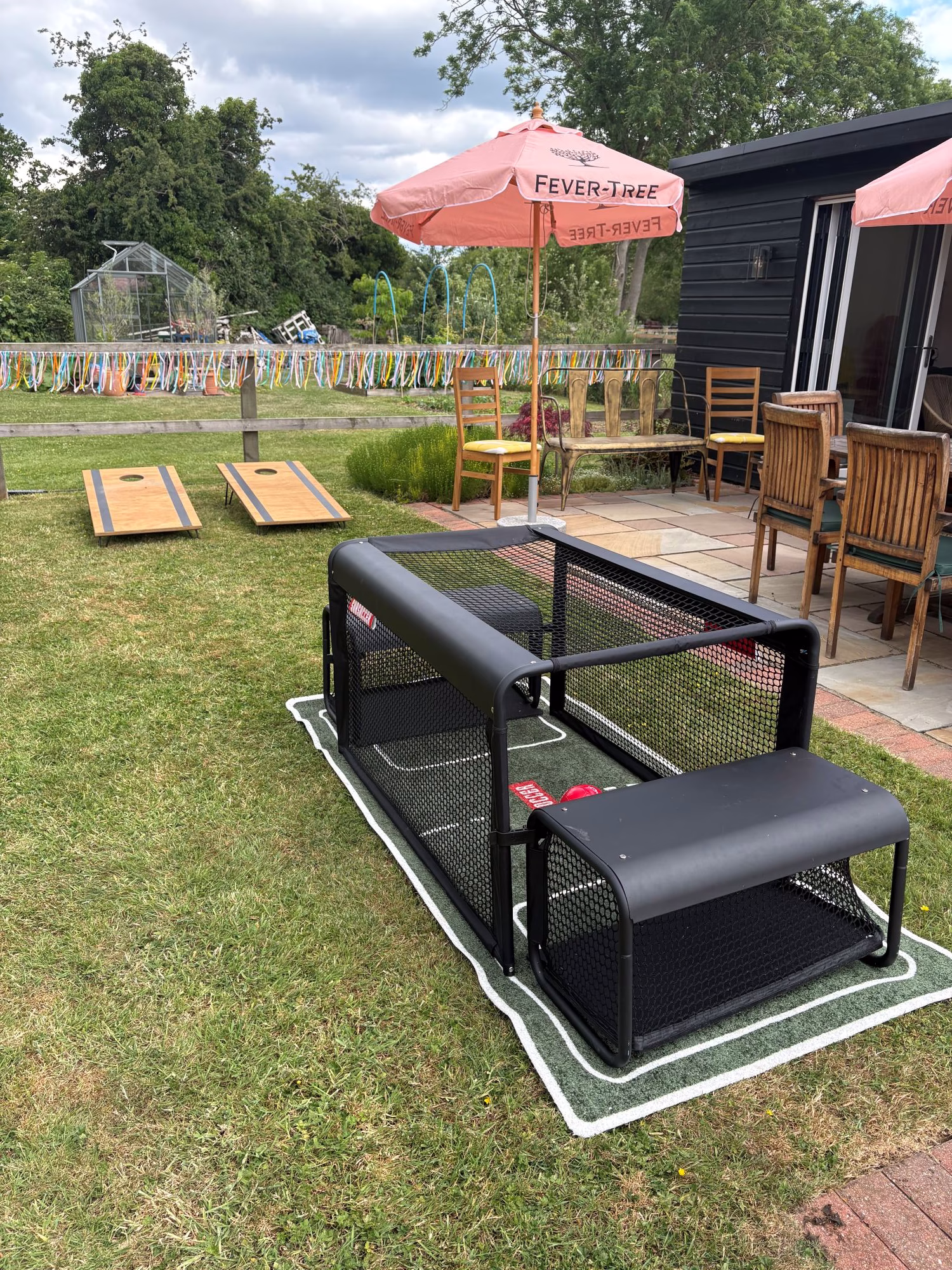 Outdoor garden games setup featuring cornhole and additional lawn games.