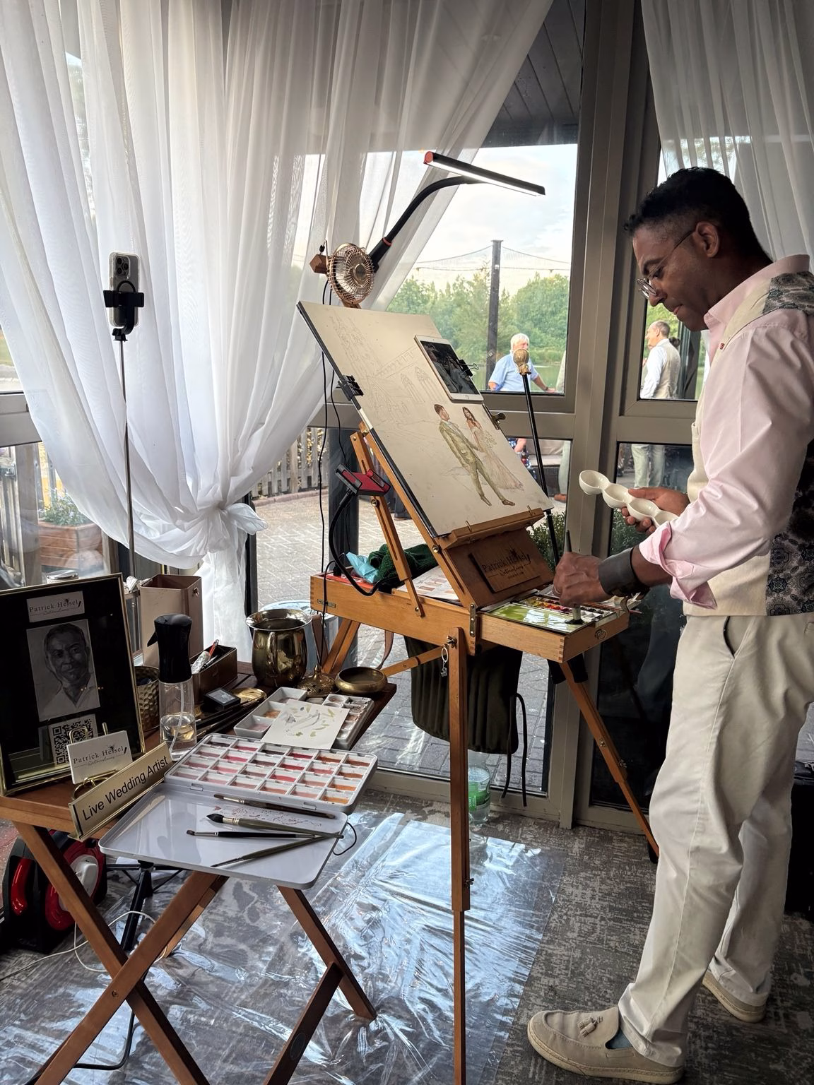 Live wedding artist painting guests at Weald of Kent Golf Club wedding reception in Maidstone, Kent