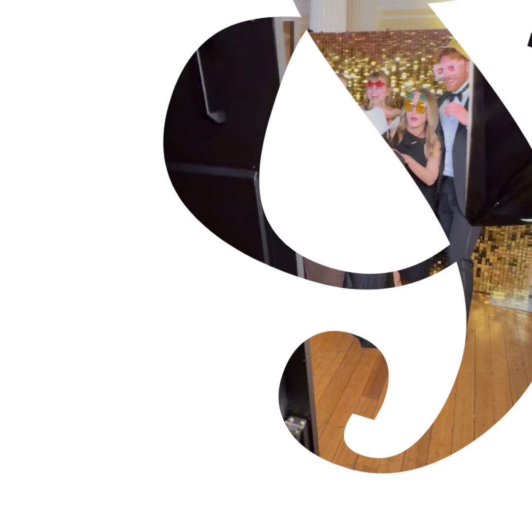 Guests in front of Gold shimmer wall at Norwich Charity Gala